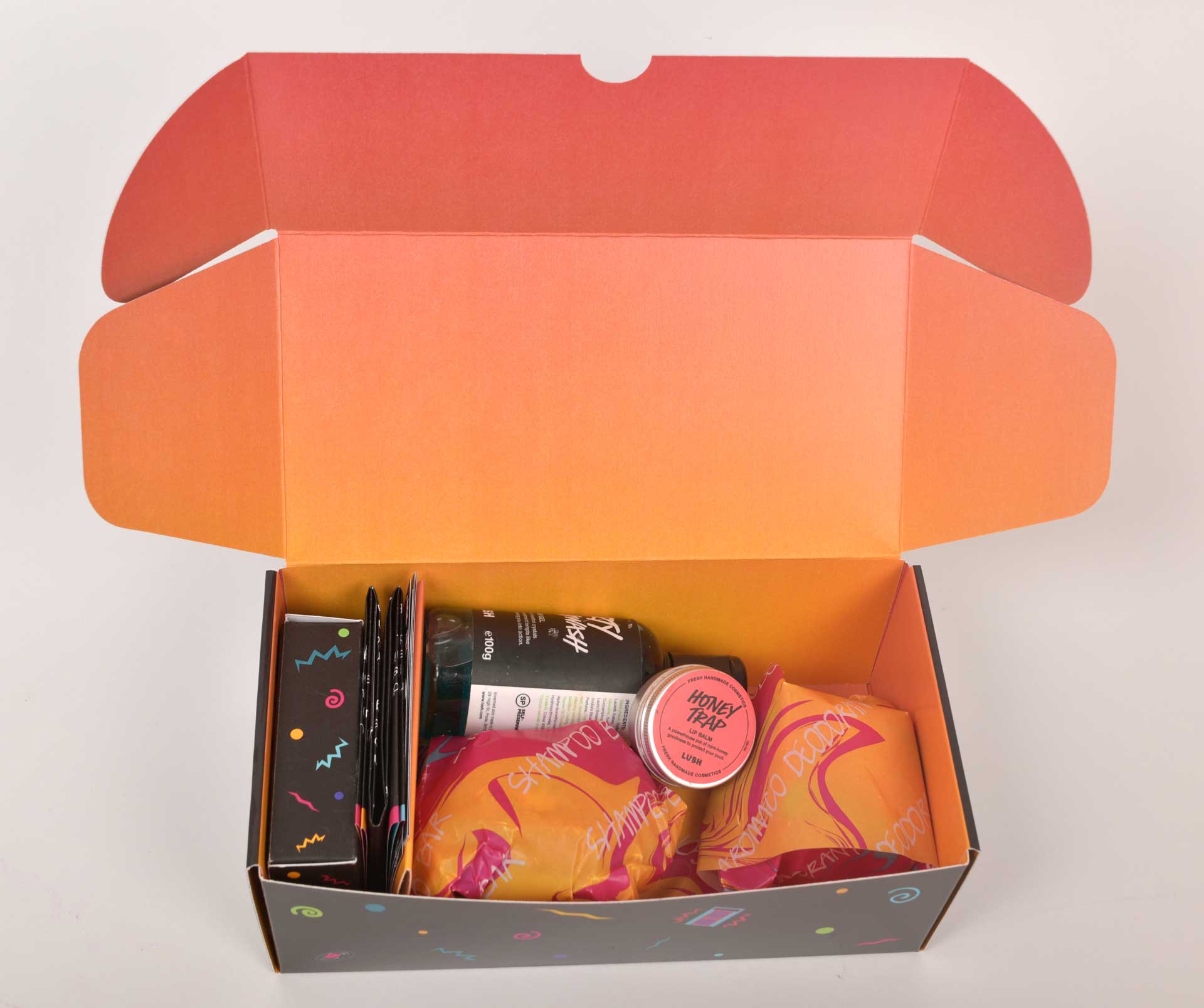 full lush kit including body care products, card game, poster, stickers, greaseproof wrapped loose items