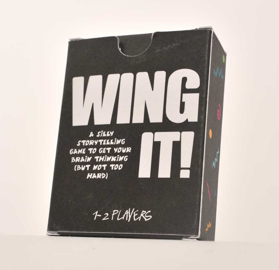 card game box. black background, white text saying 'wing it' and brightly coloured zigzag, circle, and swirl pattern.
